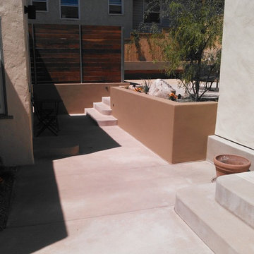 Contemporary Landscape with custom concrete work and stucco retaining wall