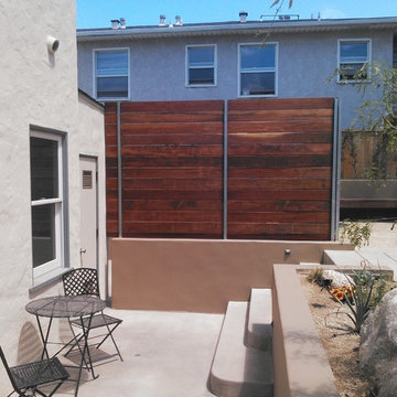 Contemporary Landscape with custom concrete work and stucco retaining wall
