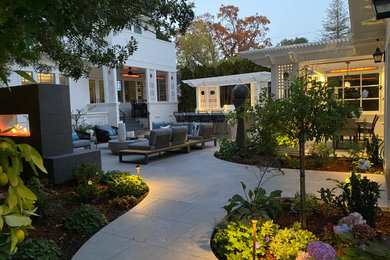Photo of a small transitional full sun backyard stone landscaping in San Francisco with a fireplace.