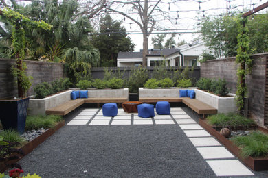 Photo of a contemporary privacy and full sun backyard concrete paver landscaping in Houston.