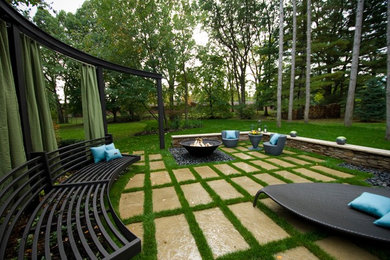 Inspiration for a contemporary backyard stone landscaping in Toronto.