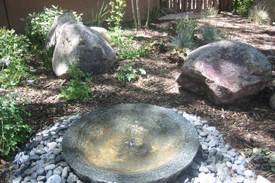 Inspiration for a mid-sized southwestern partial sun front yard stone landscaping in Albuquerque for summer.