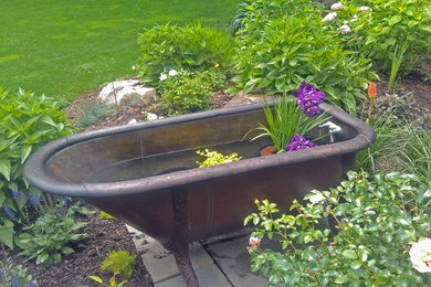 Copper bath tub re-purposed into a garden water feature.