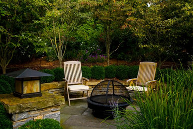 Inspiration for a mid-sized traditional backyard stone landscaping in Louisville.