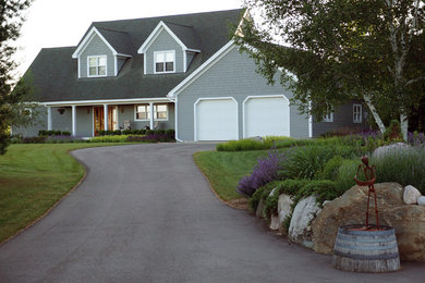 Inspiration for a large traditional full sun front yard driveway in Other.