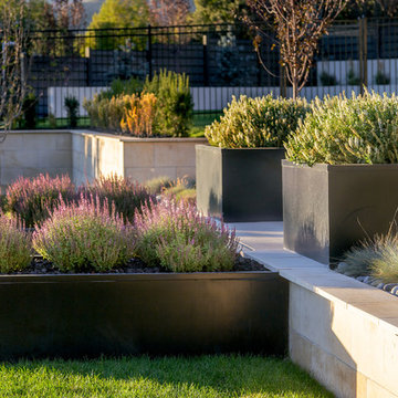 Black Planters And Retaining Walls For Modern Landscape