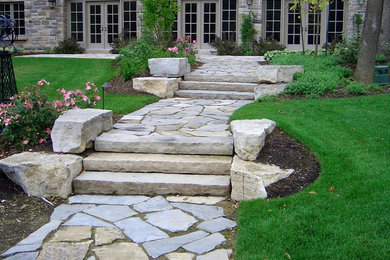 Inspiration for a large rustic hillside stone garden path in Toronto.