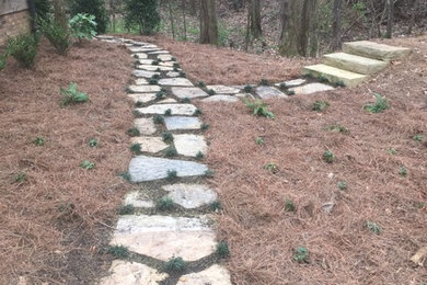 Photo of a mid-sized rustic partial sun front yard concrete paver garden path in Other for spring.