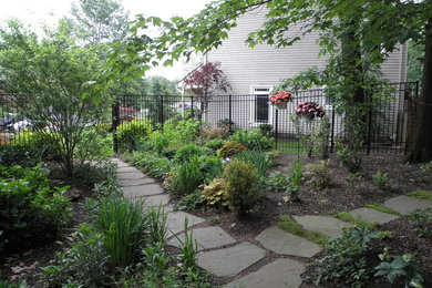 Inspiration for a medium sized classic front partial sun garden in New York with a garden path and natural stone paving.