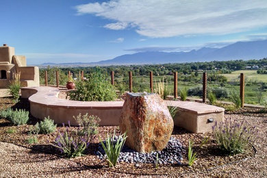 Photo of a southwestern full sun stone landscaping in Albuquerque for summer.