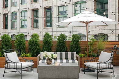 Design ideas for a large contemporary shade rooftop concrete paver landscaping in New York for summer.
