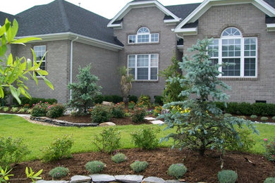 Inspiration for a large traditional partial sun front yard stone garden path in Other.