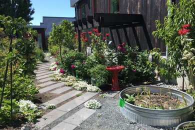 Inspiration for a modern backyard concrete paver vegetable garden landscape in Vancouver.