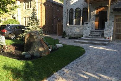 This is an example of a traditional front yard brick driveway in Toronto.
