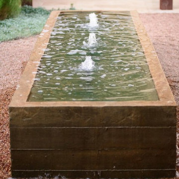 Custom Board Formed Water Feature in Pea Gravel Courtyard