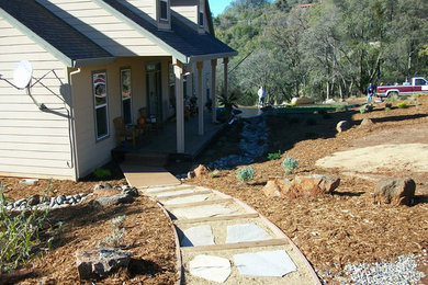 Photo of a mid-sized partial sun front yard concrete paver landscaping in Sacramento.