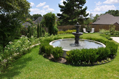 Photo of a large traditional full sun backyard water fountain landscape in Austin.