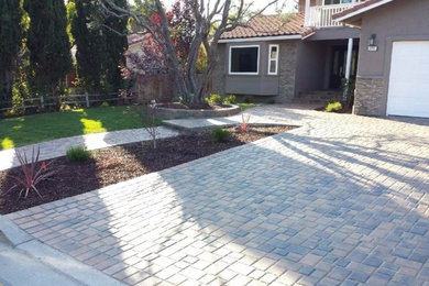 Medium sized classic front driveway garden in San Francisco with brick paving.