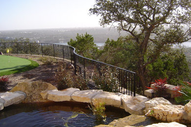 Photo of a large full sun backyard landscaping in Austin for spring.