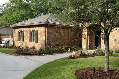 This is an example of a large traditional full sun front yard concrete paver garden path in Houston.