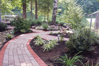 This is an example of a transitional brick landscaping in Other.