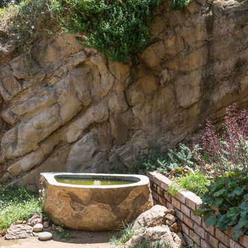 Custom water feature next to hillside and native plantings