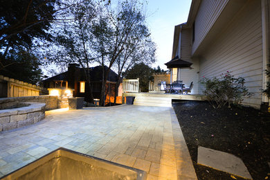 This is an example of a traditional partial sun backyard landscaping in Atlanta with a fire pit and decking for summer.