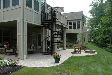 Photo of a mid-sized eclectic shade backyard concrete paver landscaping in Columbus with a fire pit.