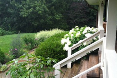 Photo of a mid-sized farmhouse front yard garden path in Other.
