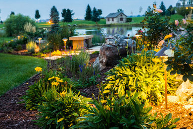 Inspiration for a large traditional full sun backyard mulch landscaping in Denver.