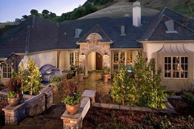 This is an example of a large traditional front yard stone landscaping in San Francisco.
