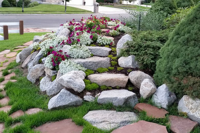 Photo of a large rustic full sun front yard stone landscaping in Salt Lake City.