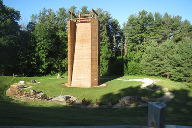 Photo of a huge craftsman full sun hillside outdoor sport court in New York.