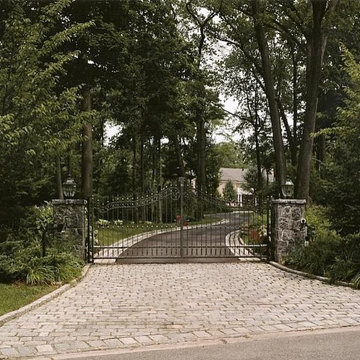 Driveway Entrance with Custom Iron Gates, Stone Piers and Cobblestone Inlay