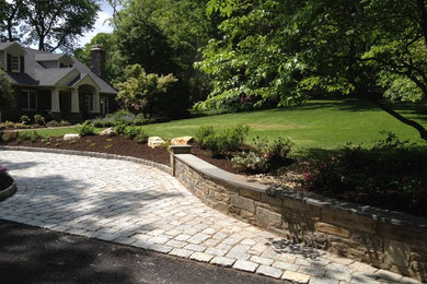 Photo of a mid-sized transitional partial sun front yard concrete paver landscaping in Philadelphia.