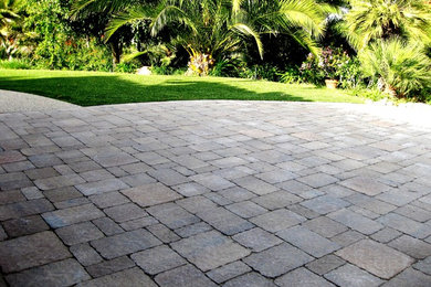 Medium sized traditional front driveway partial sun garden in New York with brick paving.