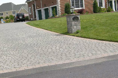 Design ideas for a large traditional full sun stone driveway in New York.
