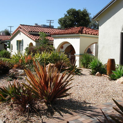 Design ideas for a mid-sized southwestern drought-tolerant and full sun front yard concrete paver landscaping in Los Angeles.
