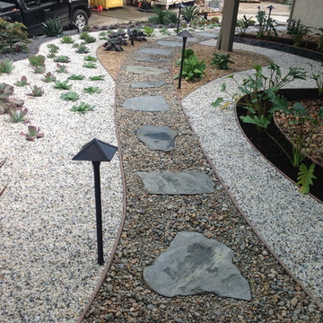 Drought-tolerant landscape design with flagstone walkway