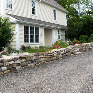 Dry laid stone walls separate gardens from farm yard landscape.