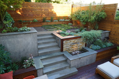 Photo of a mid-sized contemporary partial sun backyard retaining wall landscape in San Francisco with decking.