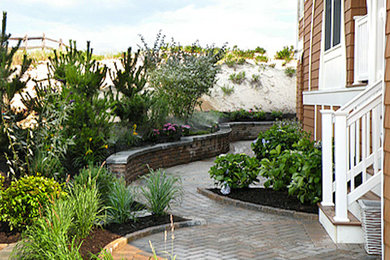 Inspiration for a coastal full sun side yard concrete paver retaining wall landscape in New York for summer.