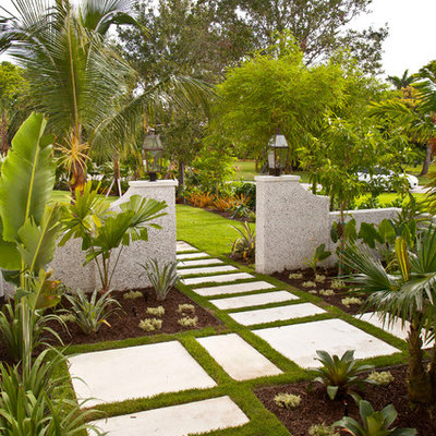 This is an example of a mid-sized tropical full sun front yard concrete paver garden path in Tampa.