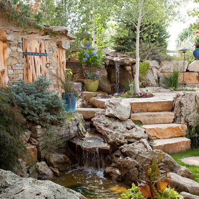 Design ideas for a large traditional partial sun backyard stone landscaping in Denver.