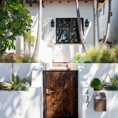 This is an example of a mediterranean partial sun front yard brick garden path in Los Angeles.