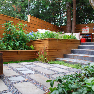 Photo of a small modern partial sun courtyard stone vegetable garden landscape in Seattle.
