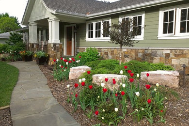 Inspiration for a mid-sized traditional partial sun front yard stone formal garden in Minneapolis.
