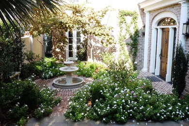 Inspiration for a small contemporary courtyard water fountain landscape in Charleston for summer.