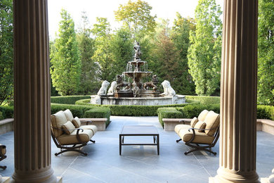 This is an example of a traditional backyard stone formal garden in Toronto.
