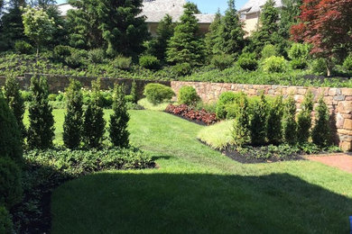 Inspiration for a medium sized classic back formal full sun garden in Philadelphia with a retaining wall.